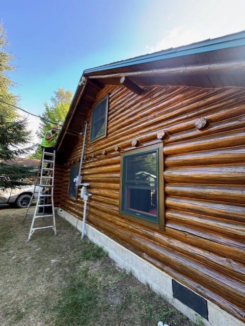 Rich wood finish along the exterior logs of a cabin